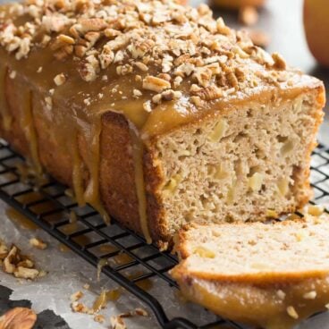 This Praline Glazed Apple Bread is so moist and decadent! It's loaded with apples and covered in an easy caramel glaze and chopped pecans -- perfect for fall or Thanksgiving baking! Includes step by step recipe video. | fall baking | thanksgiving brunch | breakfast | caramel | pecan | easy | apple picking | christmas | holiday