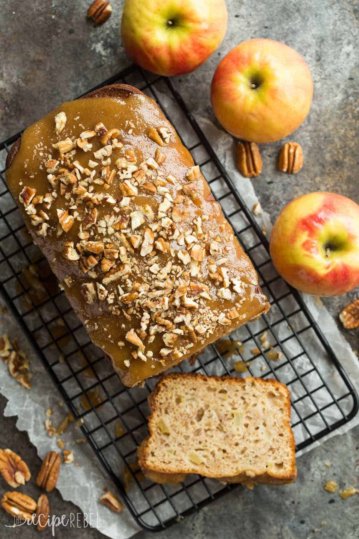 overhead image of caramel apple bread on black cooling rack with chopped pecans