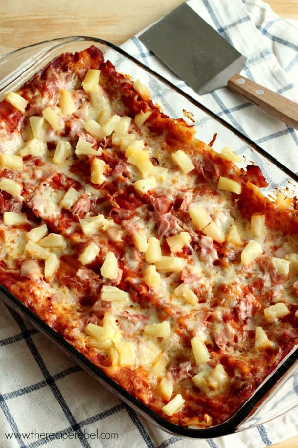 glass baking dish with whole hawaiian lasagna on white and blue checked towel