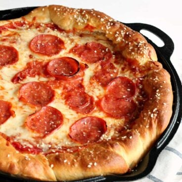 Deep-Dish Pretzel Crust Pizza -- the combination of the chewy, salty pretzel dough, sweet tomato sauce, spicy pepperoni and melty cheese is out of this world! You need to try this! www.thereciperebel.com