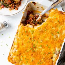 casserole dish of meat lovers shepherds pie with metal scoop