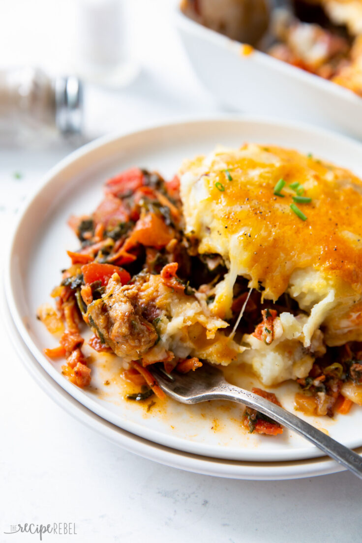 close up image of meat lovers shepherds pie on white plate