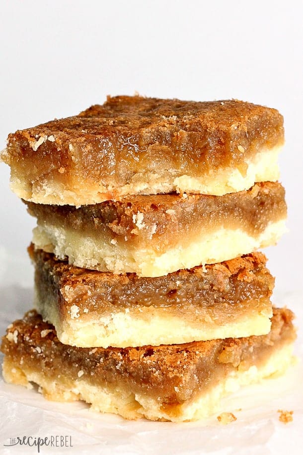 stack of four butter tart squares with bite taken out of top bar
