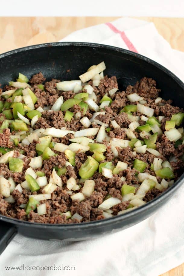 ground beef peppers and onions cooked in black skillet