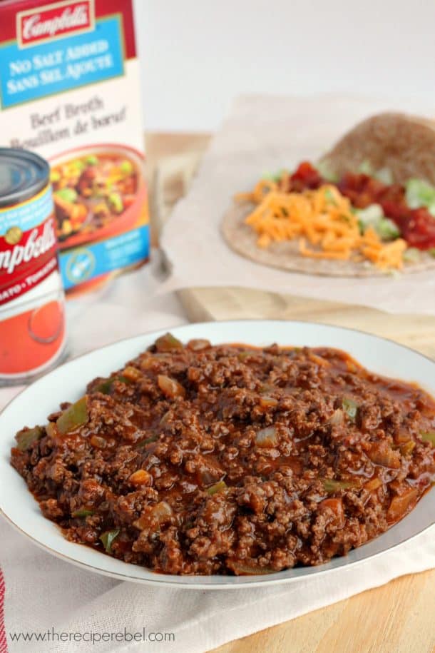 saucy taco meat on white plate in front of campbells tomato soup and beef broth