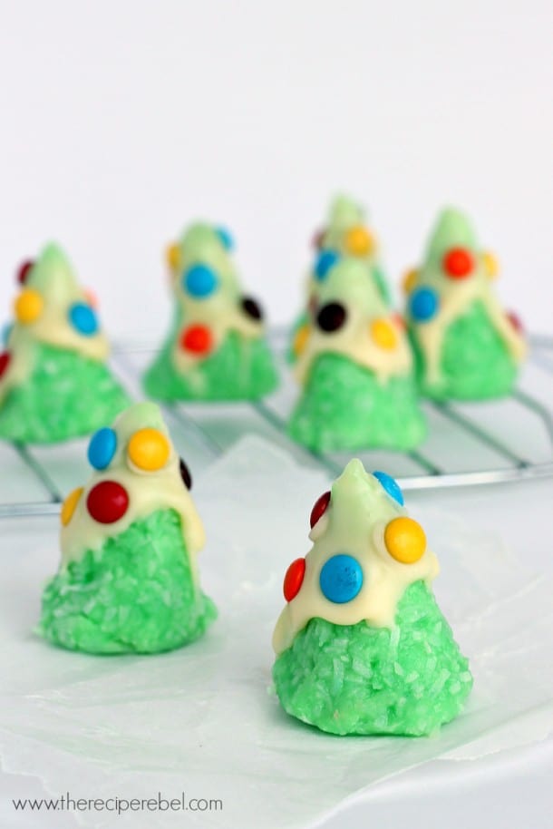 Image shows several Christmas Tree cookies on a white counter