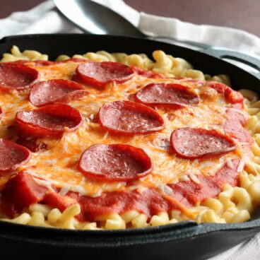 Pepperoni Pizza Mac and Cheese: made completely in one pot or skillet! Because the only way pizza could get better is if you made it on a mac & cheese crust. www.thereciperebel.com