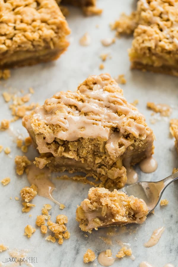 apple crisp blondies with maple glaze and bite taken with fork