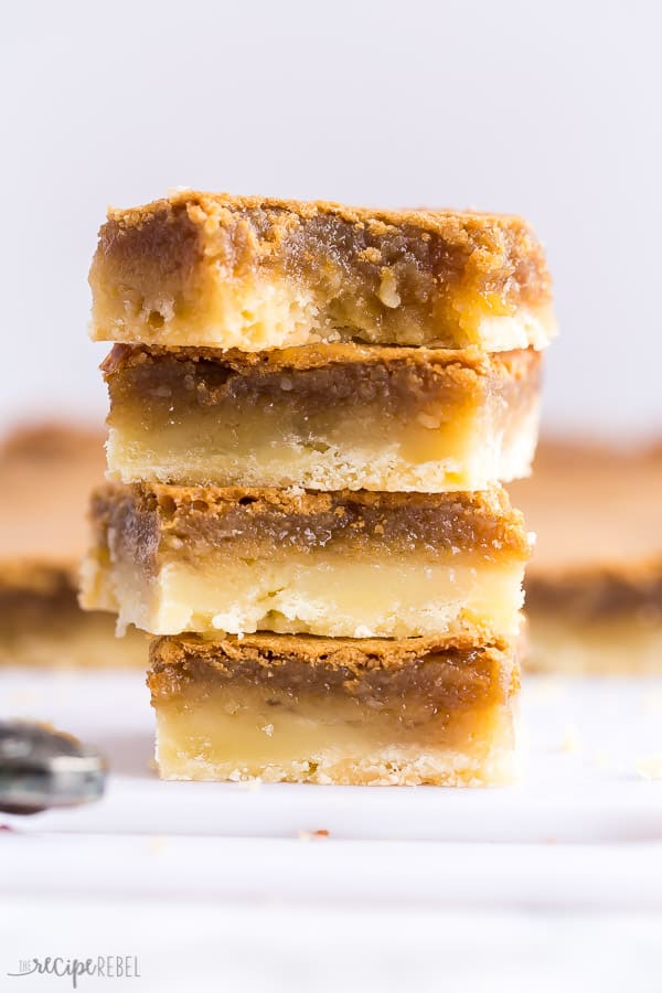 These Butter Tart Squares are so sweet and gooey -- a shortbread crust makes these so easy and SO good! So much quicker than butter tarts. #baking #dessert #recipes #Christmas butter tart squares stack of four squares close up