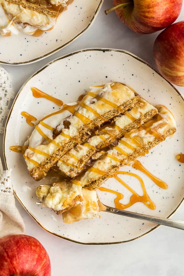 slice of apple icebox cake on white plate with caramel drizzle