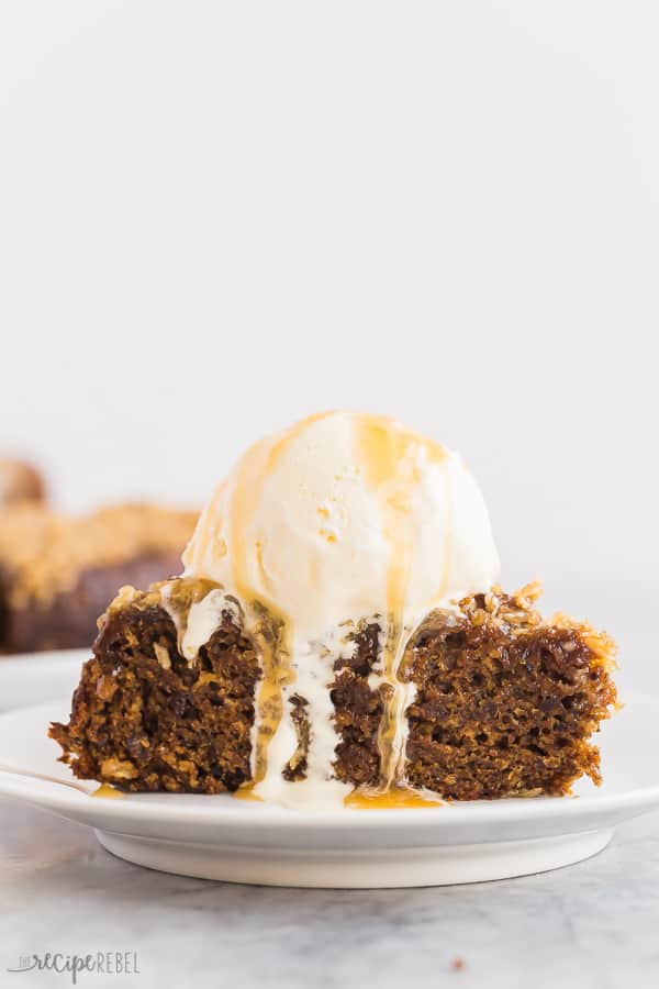 coconut date cake with ice cream and caramel close up on white plate