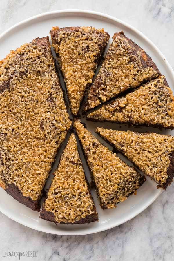 coconut date pudding cake overhead on white plate on marble background