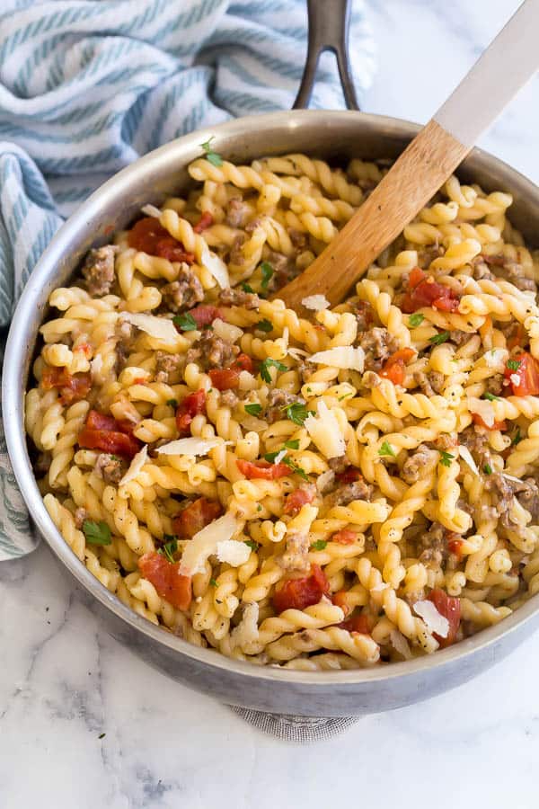 close up image of sausage tomato pasta in pan