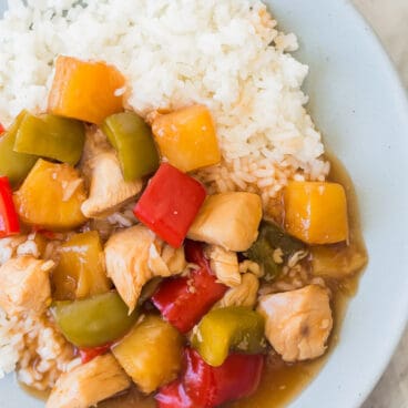 slow cooker sweet and sour chicken on blue plate