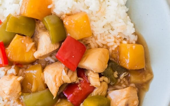 slow cooker sweet and sour chicken on blue plate