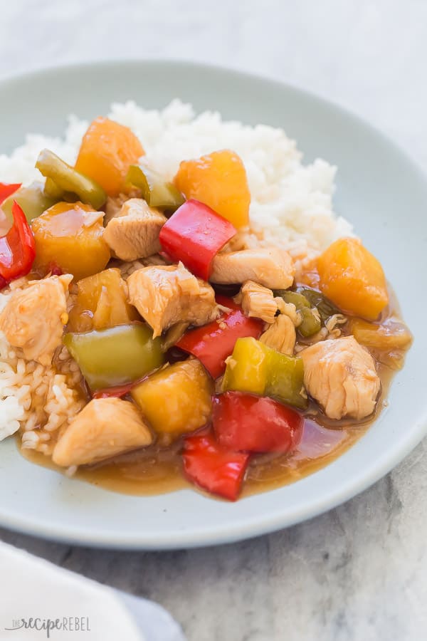 crockpot sweet and sour chicken on plate close up on grey marble