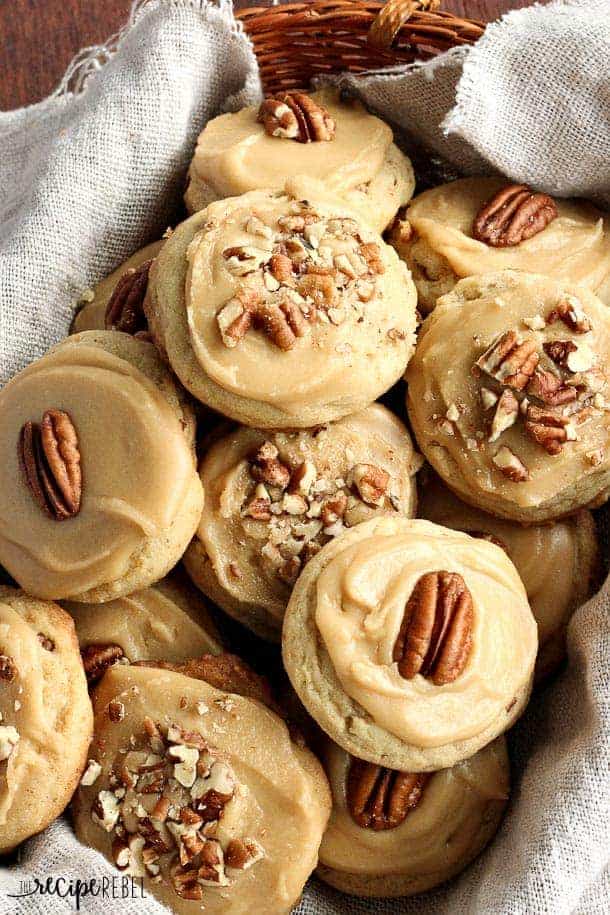brown sugar pecan cookies overhead in basket with halved and chopped pecans on top