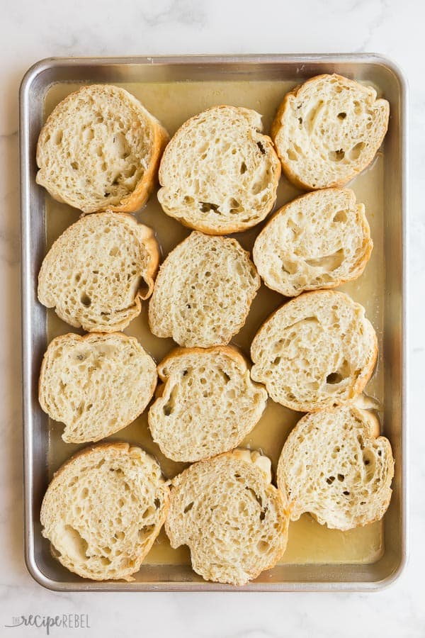 overnight french toast sheet pan before baking on white marble background