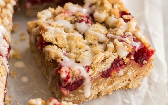 close up image of one cranberry bar with drizzle of glaze