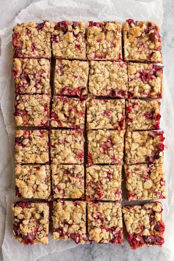 These Cranberry Caramel Bars have a crumbly oat crust, filled with tart cranberries and sweet caramel -- a match made in heaven! #dessert #cranberry #christmas #recipes cranberry caramel bars overhead cut into squares