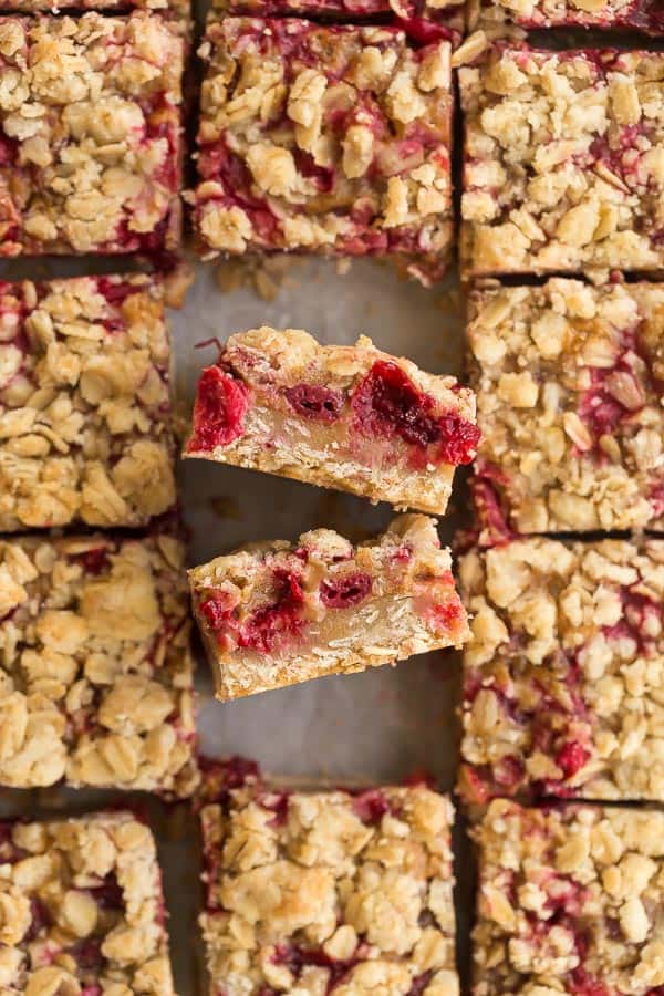 cranberry caramel bars with two pointing up to reveal inside