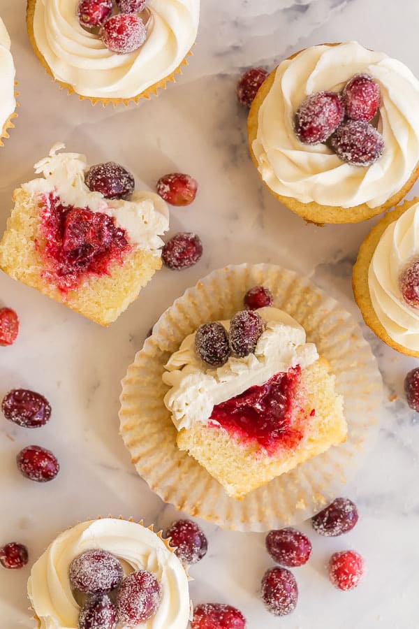 overhead image of cranberry vanilla cupcakes with one cut open