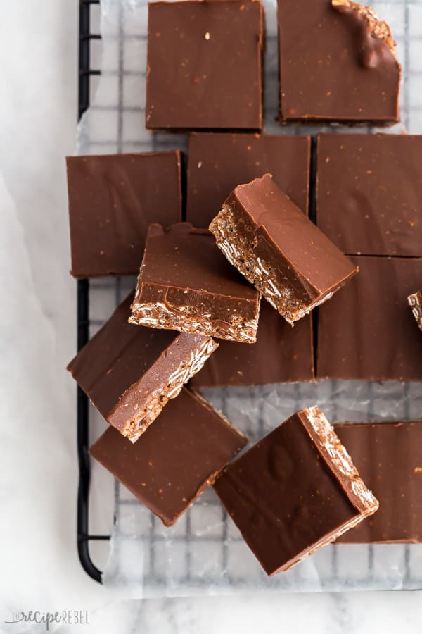These Chocolate Crunch Bars are a no bake dessert that comes together in minutes! Chewy, fudgy, and crunchy, they're sure to be a family favorite! #chocolate #bars #baking #dessert crunch bars cut into squares on baking rack overhead