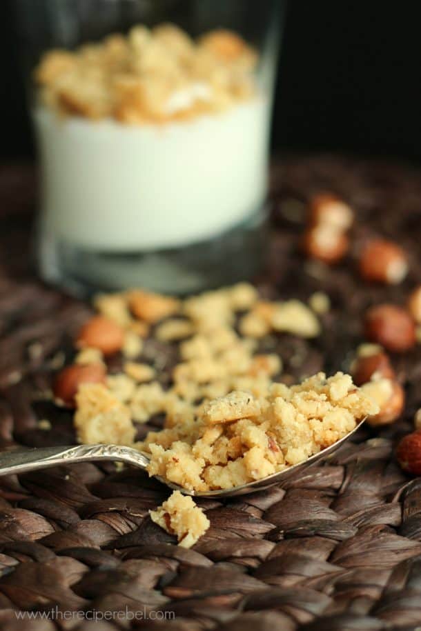 spoonful of hazelnut and brown sugar crumble resting on brown placemat