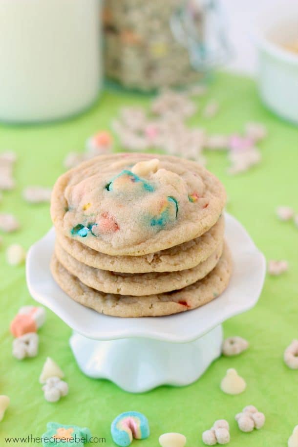 stack of four lucky charms cookies with lucky charms all around