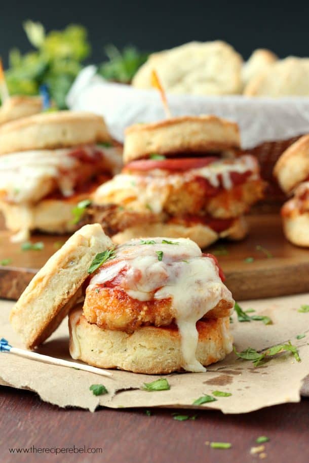 Chicken Pizziola Sliders on Garlic Herb Biscuits: perfect oven-fried chicken topped with pizza sauce, pepperoni and cheese and piled high on a flaky, homemade biscuit. It doesn't get better than this! www.thereciperebel.com open faced biscuit sandwich with pizza sauce and melted mozzarella