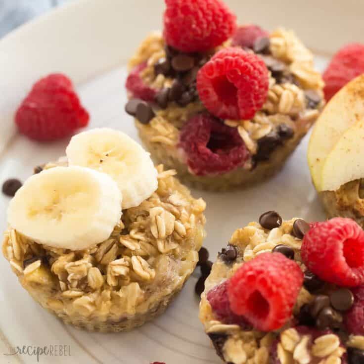 four ingredient baked oatmeal cups on white plate with banana slices and raspberries