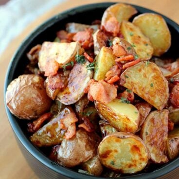 Warm Maple Bacon Potato Salad: the best kind of salad! Crispy roasted potatoes with a smoky, sweet, tangy vinaigrette. www.thereciperebel.com