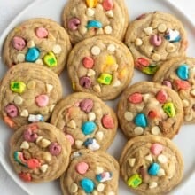 overhead image of white chocolate lucky charms cookies on a white plate.