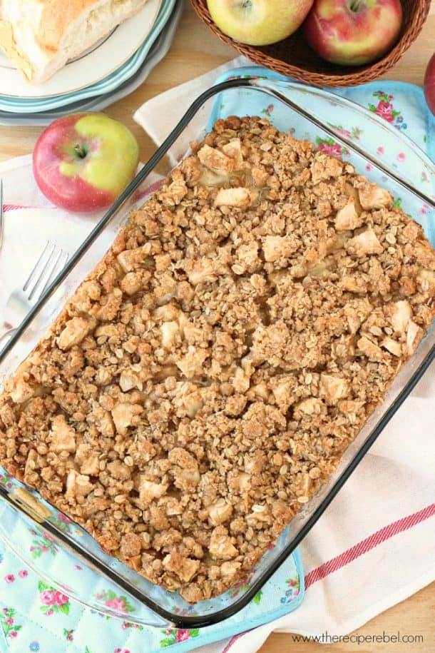 overhead image of french toast casserole topped with apple crisp with apples on the side