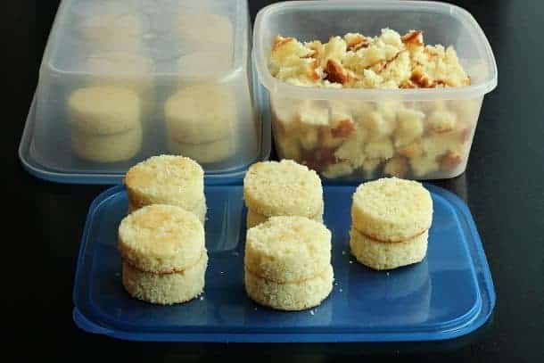 image of vanilla cake cut into rounds and pieces left over in container