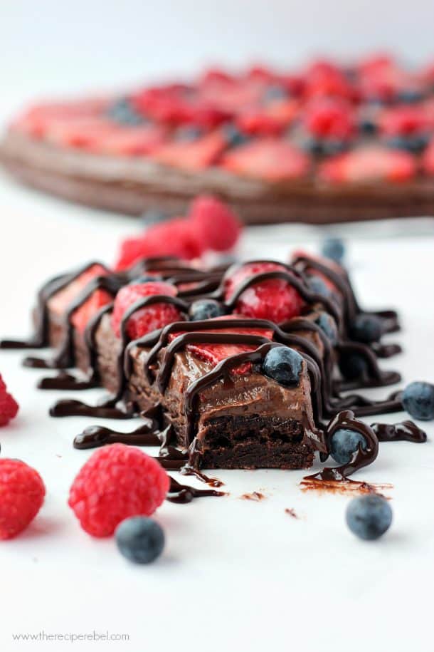 close up image of slice of brownie nutella pizza with a bite off the end