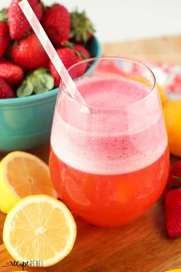 Sensational Strawberry Lemon Slush: full of strawberry and lemon flavor and is so refreshing! Keep it in the freezer and pull it out for your next barbecue or potluck! www.thereciperebel.com stemless wine glass with pink strawberry lemon slush with pink paper straw