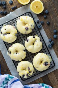 These Baked Lemon Blueberry Doughnuts are fluffy, packed with citrus flavor and bursting with blueberries and covered in a tangy glaze! Baked donuts are the perfect healthy breakfast or snack. Includes step by step recipe video. | baked donuts | lemon recipe | lemon dessert | baking | lemon donuts