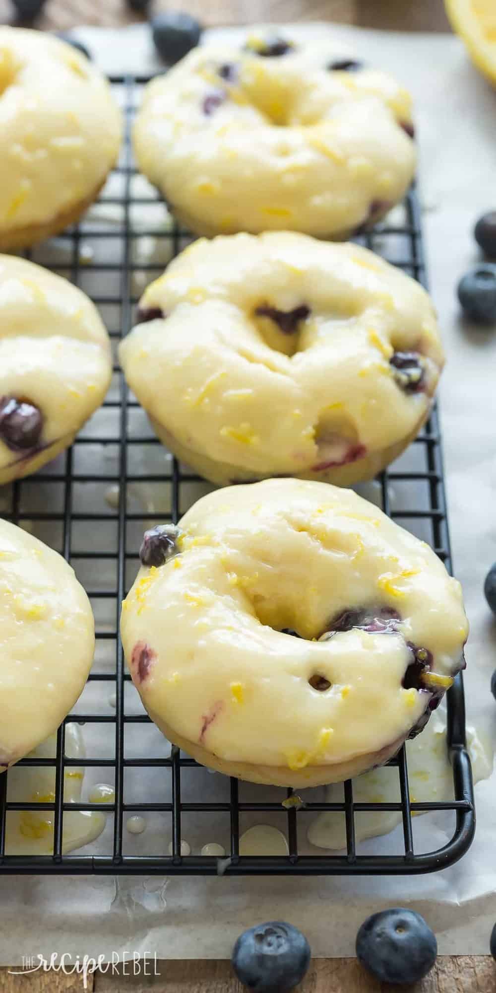 These Baked Lemon Blueberry Doughnuts are fluffy, packed with citrus flavor and bursting with blueberries and covered in a tangy glaze! Baked donuts are the perfect healthy breakfast or snack. Includes step by step recipe video. | baked donuts | lemon recipe | lemon dessert | baking | lemon donuts