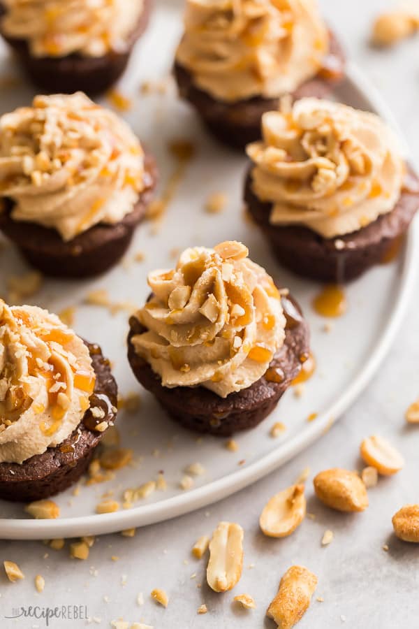 close up image of brownies bites drizzled with caramel and sprinkled with peanuts
