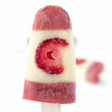 Canadian Flag Pudding Pops: creamy vanilla pudding pops, with a strawberry center made to look like the Canadian flag (or as close as I could get anyways!). The perfect Canada Day treat! www.thereciperebel.com