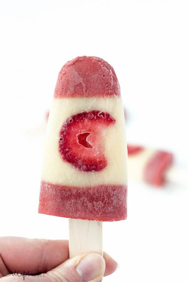 hand holding up canadian flag pudding pop with strawberry as the center maple leaf