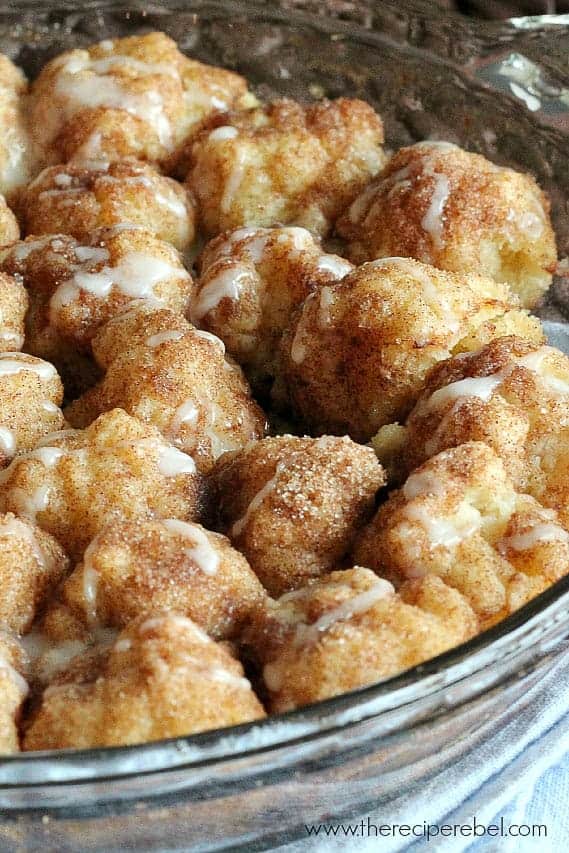 cinnamon roll bites in glass pie plate with white glaze