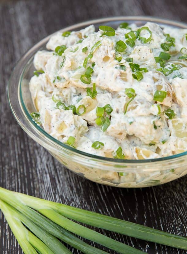 four ingredient class potato salad in glass bowl with green onions