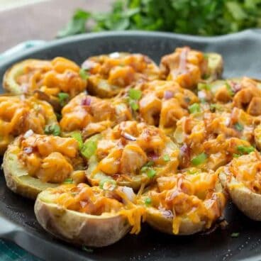 Grilled BBQ Chicken Potato Skins: BBQ chicken, pineapple, red onion, barbecue sauce and cheese, all loaded up in a tender potato shell, and grilled on the barbecue! The perfect summer appetizer or picnic lunch. www.thereciperebel.com