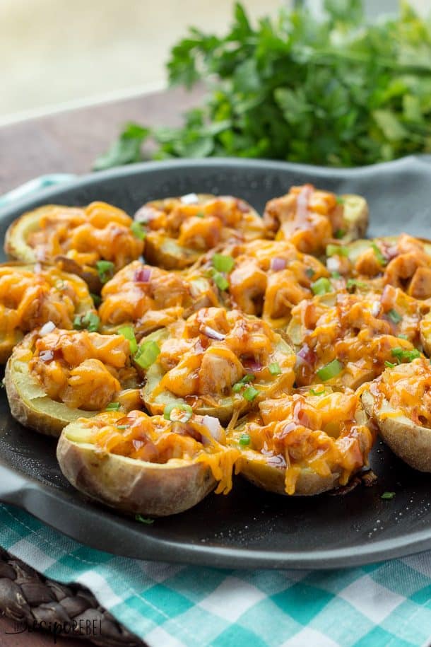 barbecue chicken potato skins in potato halves with cheddar cheese red onion and green onions