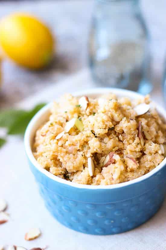 lemon herb quinoa salad in blue bowl with slivered almonds