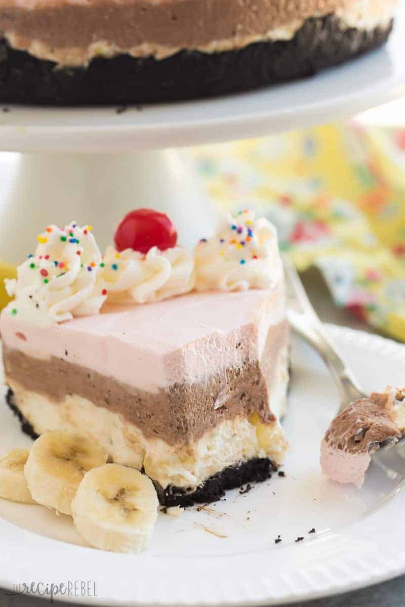slice of no bake banana split cheesecake on white plate with bite taken off the end