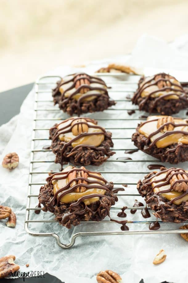 6 no bake turtle cookies on a wire cooling rack with parchment underneath