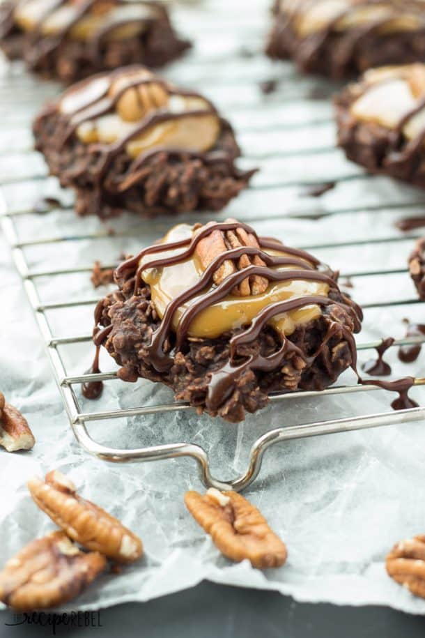 no bake turtle cookies on a wire cooling rack with caramel and pecan half